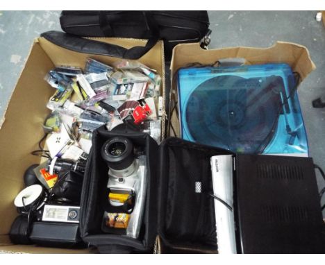 A large quantity of electric items to include cameras and camera accessories,  DVD players to include Grundig and Maxim, a re