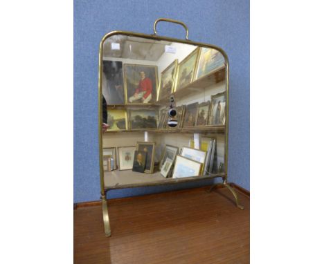 A brass and mirrored fire screen 