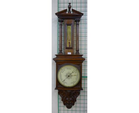 A Victorian carved oak aneroid barometer 