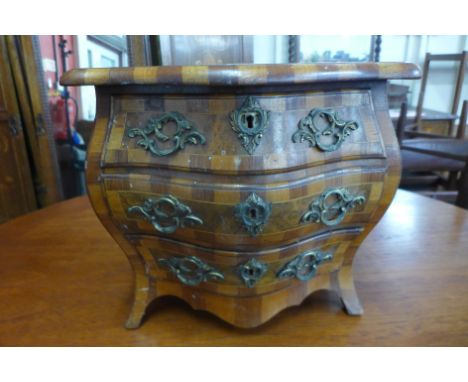 A 19th Century Dutch miniature/apprentice's walnut and parquetry inlaid bombe shaped commode, 34cms h