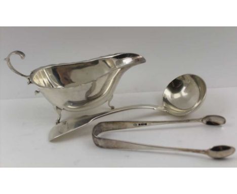 CHARLES BOYTON A VICTORIAN SILVER SAUCE LADLE, fiddle pattern, London 1847, with engraved heraldic crest, together with a sil