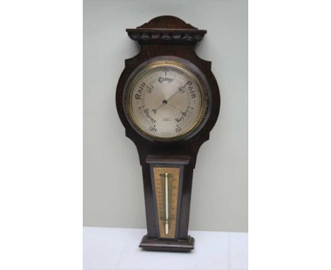A 20TH CENTURY OAK CASED BAROMETER THERMOMETER, the calibrated dial, 15cm in diameter, the case 54cm high 