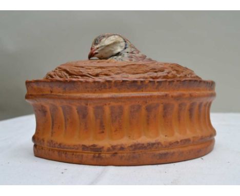 A FRENCH ELIPTICAL CERAMIC GAME DISH, the cover with a painted game bird head, 22cm 