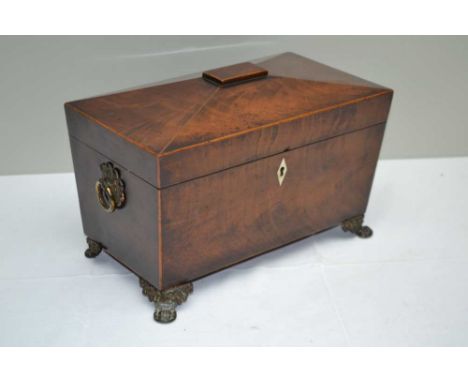 A 19TH CENTURY MAHOGANY SARGOPHAGUS FORM TEA CADDY, the cover opens to reveal twin lidded containers flanking a recess for a 