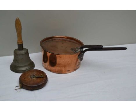 A CAST METAL HAND BELL with turned wood handle, 26cm high, together with a 19th century COPPER SAUCEPAN with lid, 11cm high, 