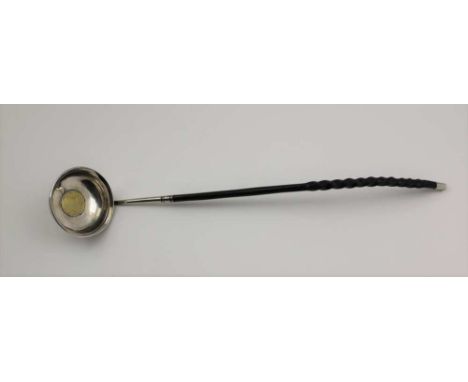 AN 18TH CENTURY TODDY LADLE, the bowl inset with a gilded George III 1787 shilling, having twisted whale bone handle, 37cm lo