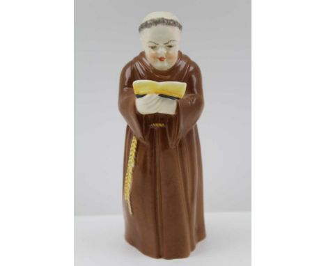 A ROYAL WORCESTER BONE CHINA CANDLE SNUFFER, modelled and painted as a monk with an open book, 12.5cm high 