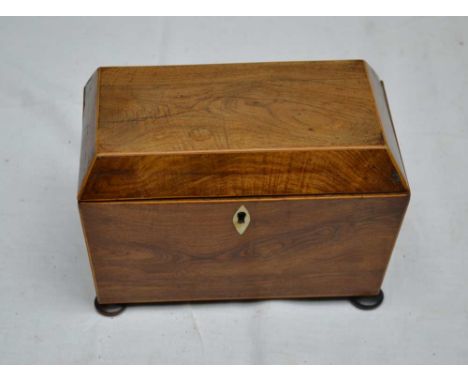 A 19TH CENTURY WALNUT TEA CADDY OF SARGOPHAGUS FORM, fitted two inner lids, raised on bun feet, 20cm wide 