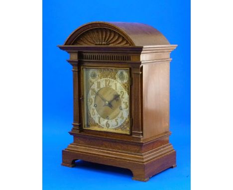 An early 20thC oak cased Westminster Chimes mantel Clock, of arched form with carved crest and fluted pilasters, the brass di
