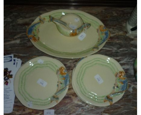 A Clarice Cliff nine-piece Fish service, the rims moulded in relief and painted in colours with fish, comprising a serving pl