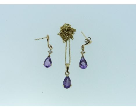 A Pendant and matching Earrings set, the pendant with tear drop amethyst paste, suspension loop and fine 9ct yellow gold trac