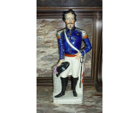 A Staffordshire pottery portrait figure of Louis Napoleon, on titled base, painted in colours and gilt, 15½in (39.25cm) high.