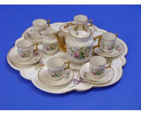 An early 20thC sixteen piece Tea service, painted in colours with floral sprays, the bamboo style handles decorated in gilt, 