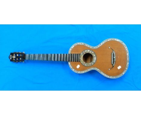 A 19thC French Parlour Guitar, the open peg box with brass tuning strips and mother of pearl pegs, signed 'Demet', 17 fret eb
