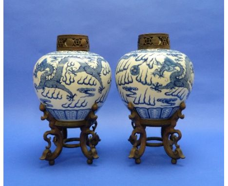 A pair of late 19thC Chinese blue and white porcelain Jars, painted with dragons chasing the flaming pearl of wisdom, each wi