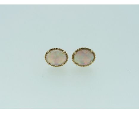 A pair of oval Australian opal Earrings, with ropework borders, mounted in yellow metal (2) 