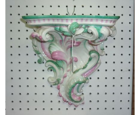 A 19thC English porcelain leaf and scroll Wall Bracket, of serpentine form with green and pink decoration, some damage and lo