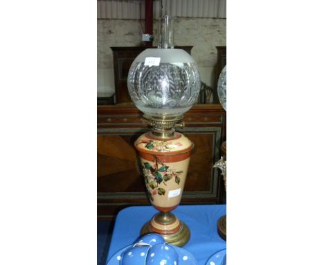 A Victorian embossed brass and ceramic Oil Lamp, the base with floral decoration, cracked, and an etched glass shade, 25in (6