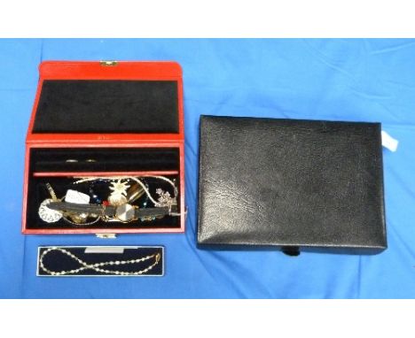 A fitted Jewellery Box, in black calf and with red velvet interior, together with a red leather fitted jewellery box with bla