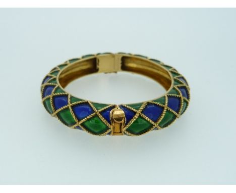 An attractive Mauboussin gold and enamel hinged Bangle, the front and back with diamond shaped ropework crosses, filled with 