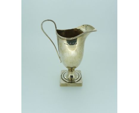 A late Victorian silver Cream Jug, by Hilliard & Thomason, hallmarked Birmingham 1897, of helmet shape with reeded handle, ra