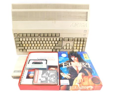 An Amiga Commodore computer model A500, with an A5 20 audio video receiver, books, instructions and cassettes.  (a quantity)