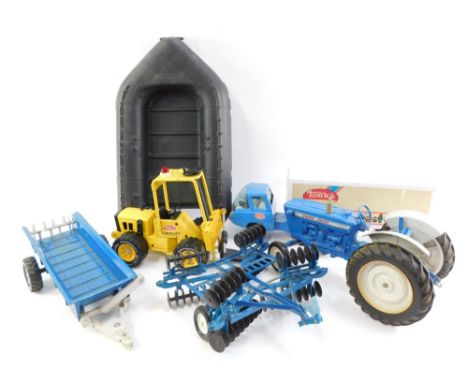 Ertl and Tonka die cast farm vehicles and machinery, comprising a Ford 4000 tractor, bail loader and plough, a Tonka forklift