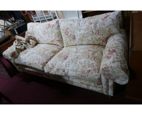 A Zoffany 'Tavistock' range sofa, with floral upholstery, raised on turned legs 