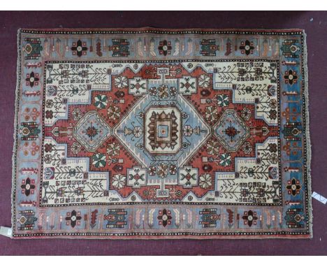 A North West Persian Nahawand rug, central diamond medallion with repeating petal motifs on an ivory field within stylised ja