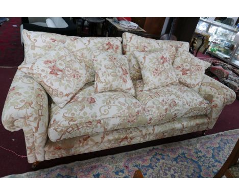 A Zoffany 'Tavistock' range sofa, with floral upholstery, raised on turned legs, small rip to front edge 