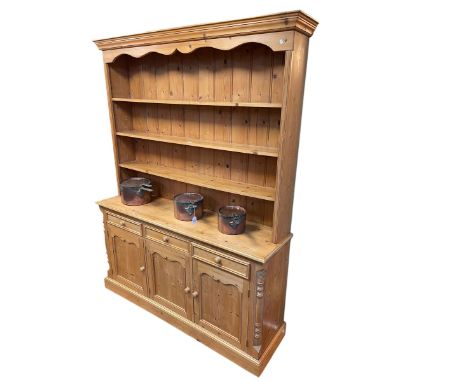 Pine dresser having shelf back above three drawers with three cupboard doors below, 197cm by 157.5cm by 40cm.