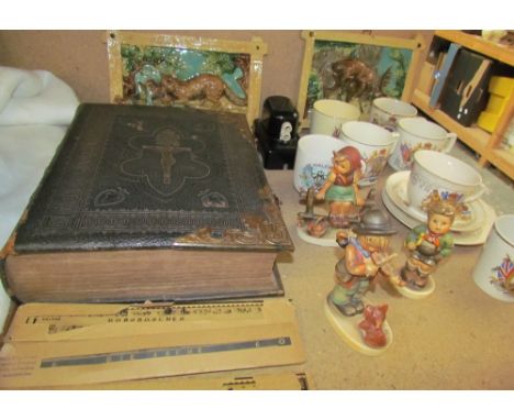 Three Goebel figures by Hummel together with a pair of Majolica plaques, commemorative wares, a bible etc