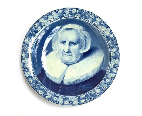 A large mid 20th century Delft charger by Joost Thooft &amp; Labouchere, decorated with an image of Elizabeth Bas after the p