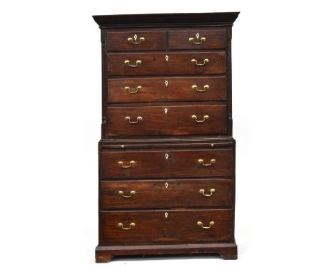 A George III provincial oak chest on chest, dentil cornice, the top with two short and three graduating drawers flanked by qu
