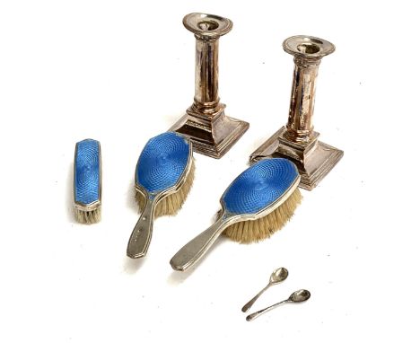 A set of silver and blue guilloche enamel brushes by Reid and Sons; two salt spoons; and two plated candlesticks 