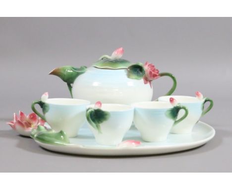 A boxed Graff porcelain six piece tea service decorated with leaves and flowers.