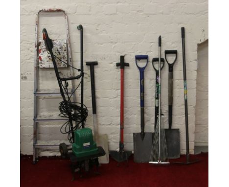 An Andrew James electric cultivator along with other garden tools and a pair of step ladders.
