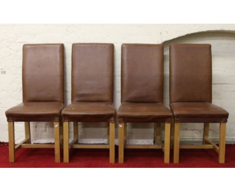 A set of four light oak and chocolate leather dining chairs.