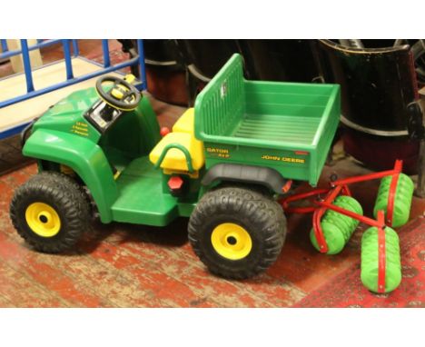 A childs John Deere 12 volt Gator 4 x 2 truck and kettler Cambridge roller 'no charger'.