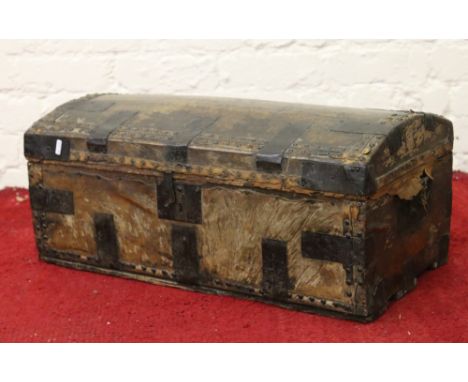 An antique hide and metal bound dome topped trunk.