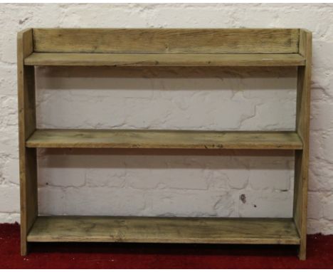 A light oak open three tier bookshelf.