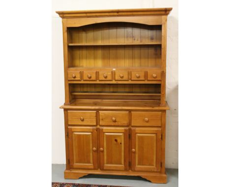 A farmhouse pine dresser raised on bracket feet.