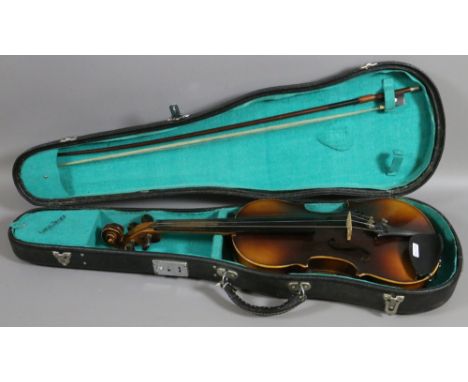 A cased copy of a Stradivarius violin and bow made in Czechoslovakian.