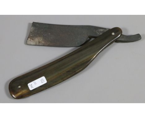 An oversized Georgian cut throat razor with steel blade and horn scales.