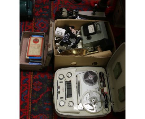 An Elizabethan tape recorder and electronic microscope along with a collection of ceramics and gas masks.