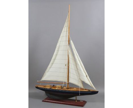 A wooden scale model of a pond yacht.