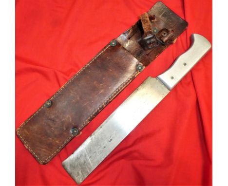 Solid aluminium grip, with full length ‘cleaver’ blade, showing use and minor sharpening. Retains leather scabbard, maker mar