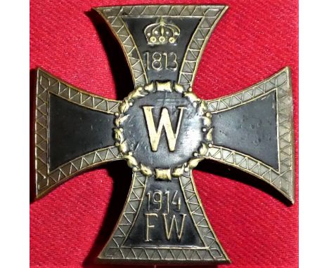 Ornate designed one piece, die-struck example, with hand-applied black enamel to face, with central royal W cypher to centre.