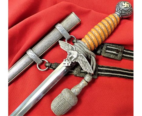 Features orange celluloid grip, with full wire wrap, gilded rotating large swastika &amp; oakleaf pommel, with nickel eagle c