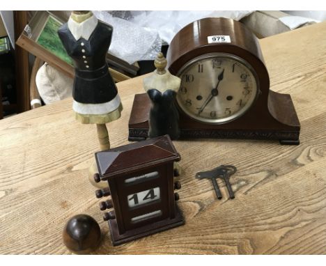 A Mahogany mantel clock a vintage desk day date calendar small wooden cloths dummies and a walnut enclosed ink well.